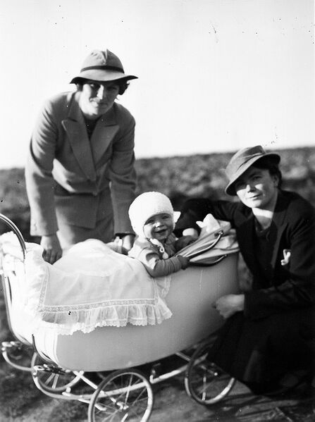 Datei:Balbina Gall 01 Hebamme, rechts, mit einem froehlichen Kind, bei dem sie Geburtshilfe geleistet hatte.jpg